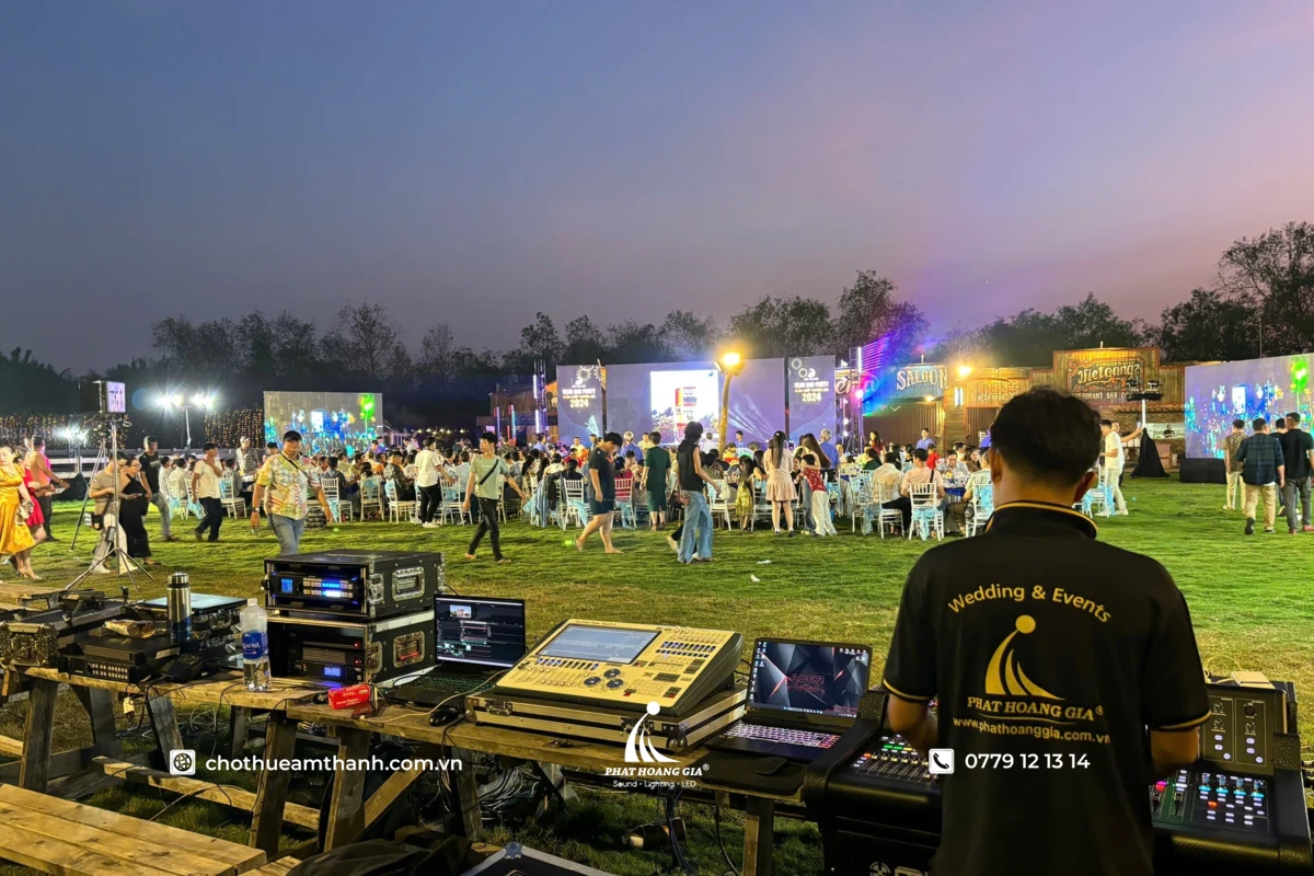Kỹ thuật viên phát hoàng gia vận hành bàn điều khiển âm thanh ánh sáng ngoài trời cho bữa tiệc tất niên 