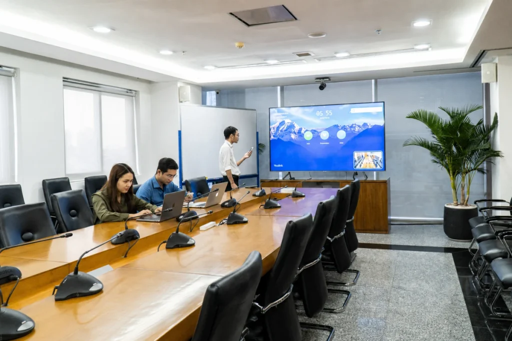 Không gian phòng họp bố trí loa treo tường và mic bàn xử lý dải âm thanh đa điểm cầu
